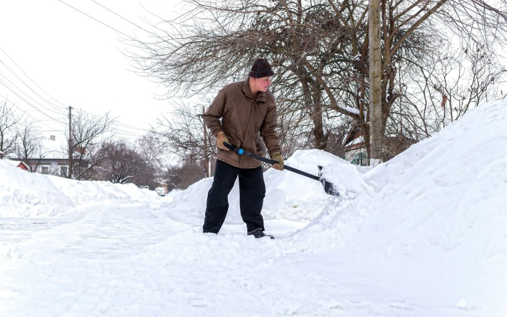 man shoveling snow in Calgary, AB