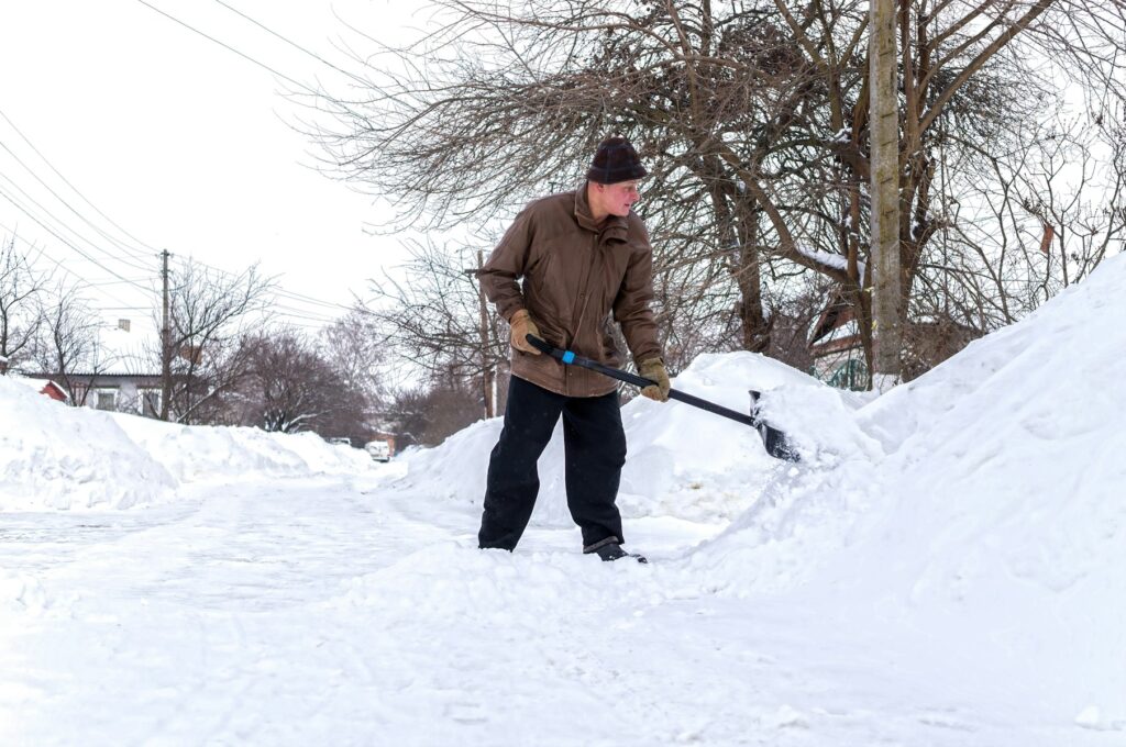 man shoveling snow in Calgary, AB